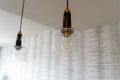 Modern looking kitchen hanging light fixtures inside a house features an exposed lightbulb