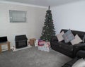 A Modern Lounge with Christmas Tree Decorated with presents at i Royalty Free Stock Photo