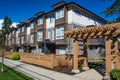 Modern low rise wood frame complex. Brand new apartment building on sunny day in spring with blooming trees. Royalty Free Stock Photo