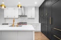A modern luxurious kitchen with white and black cabinets. Royalty Free Stock Photo