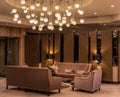 Modern luxurious lobby for hotel with comfortable sofas, arm chairs and moody lighting