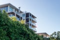 Modern luxury apartment building against blue sky and bushes Royalty Free Stock Photo