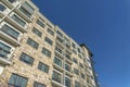 Modern luxury apartments with stone brick wall facade and small balconies Royalty Free Stock Photo