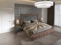 Modern luxury bed in art deco style with quilt and wooden headboard of parquet. Bedroom in brown colors Royalty Free Stock Photo