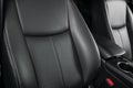 Modern luxury car black leather interior. Part of leather car seat details with stitching. Interior of prestige modern car. Comfor