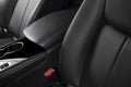 Modern luxury car black leather interior. Part of leather car seat details with stitching. Interior of prestige modern car. Comfor