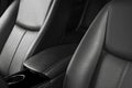 Modern luxury car black leather interior. Part of leather car seat details with stitching. Interior of prestige modern car. Comfor