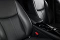 Modern luxury car black leather interior. Part of leather car seat details with stitching. Interior of prestige modern car. Comfor