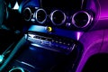 Modern luxury car inside in blue and pink tones. Interior of prestige modern car with carbon panels. Comfortable leather seats. Royalty Free Stock Photo