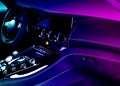 Modern luxury car inside in blue and pink tones. Interior of prestige modern car with carbon panels. Comfortable leather seats. Royalty Free Stock Photo