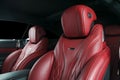 Modern Luxury car inside. Interior of prestige modern car. Comfortable leather red seats. Red perforated leather cockpit Royalty Free Stock Photo