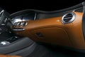Modern Luxury car inside. Interior of prestige modern car. Comfortable leather seats. Orange perforated leather cockpit. Steering