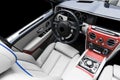 Modern Luxury car inside. Interior of a vehicle with natural wood panel. White Leather with stitching. Car detailing. Dashboard. M