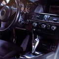 Modern luxury car Interior - steering wheel, shift lever and dashboard.