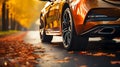 Modern luxury car\'s tires on a slippery autumn road