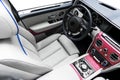 Modern Luxury car inside. Interior of a vehicle with natural wood panel. White Leather with stitching. Car detailing. Dashboard. M