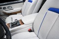 Modern luxury car white leather interior seat details with stitching. Interior of prestige modern car. White perforated leather.