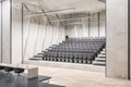 Modern luxury concrete lecture hall auditorium interior with seats and other objects. Speech, workshop and graduation concept.