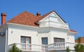 Modern luxury house with clay roof tiles, rain gutter, outdoor lighting,attic windows , balcony Royalty Free Stock Photo