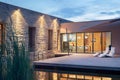Modern luxury villa terrace with swimming pool, dusk shot. Royalty Free Stock Photo