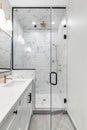 A modern, luxury white bathroom with the shower door open. Royalty Free Stock Photo