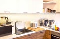 Modern machines (equipment) are in the kitchen interior. Automatic food processors culinary robots, coffee machine and