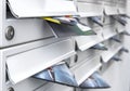 Modern mailboxes filled of flyers Royalty Free Stock Photo