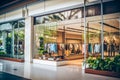 Modern mall interior, fashion store window, green plants. Royalty Free Stock Photo