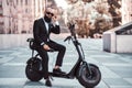 Modern man is sitting on his new electro scooter Royalty Free Stock Photo