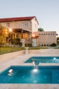 Modern mansion with flashing lights around the swimming pool Royalty Free Stock Photo
