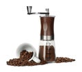 Modern manual coffee grinder with powder, beans and cup on white background Royalty Free Stock Photo