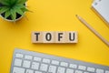 Modern marketing buzzword - TOFU Top of funne. Top view on wooden table with blocks. Top view