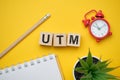 Modern marketing buzzword UTM - Urchin tracking module. Top view on wooden table with blocks. Top view