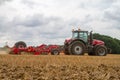 Modern massey ferguson tractor cultivating field