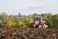 Modern massey ferguson tractor pulling a plough