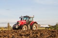 Modern massey ferguson tractor pulling a plough