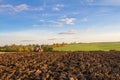 Modern massey ferguson tractor pulling a plough