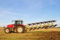 Modern massey ferguson tractor pulling a plough