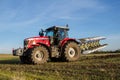 Modern massey ferguson tractor pulling a plough