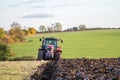 Modern massey ferguson tractor pulling a plough