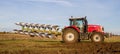 Modern massey ferguson tractor pulling a plough