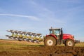 Modern massey ferguson tractor pulling a plough