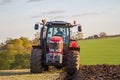 Modern massey ferguson tractor pulling a plough