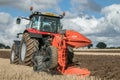 Modern massey ferguson tractor pulling a plough