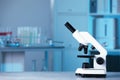 Modern medical microscope on gray table in laboratory, space for text Royalty Free Stock Photo