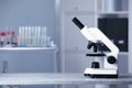 Modern medical microscope on gray table in laboratory, space for text Royalty Free Stock Photo