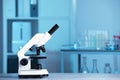 Modern medical microscope on gray table in laboratory, space for text Royalty Free Stock Photo