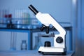 Modern medical microscope on gray table in laboratory, space for text Royalty Free Stock Photo