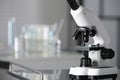 Modern medical microscope on metal table in laboratory, closeup. Space for text Royalty Free Stock Photo