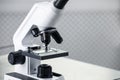 Modern medical microscope on metal table in laboratory, closeup. Space for text Royalty Free Stock Photo